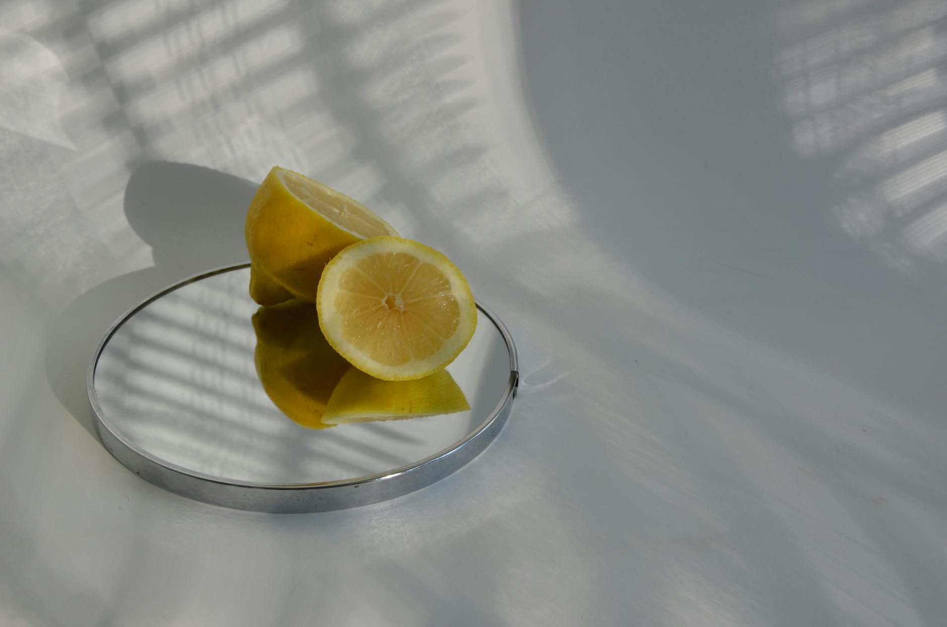 Bright ripe lemons arranged on a pastel green background, representing renewal and vitality during hormonal transition.