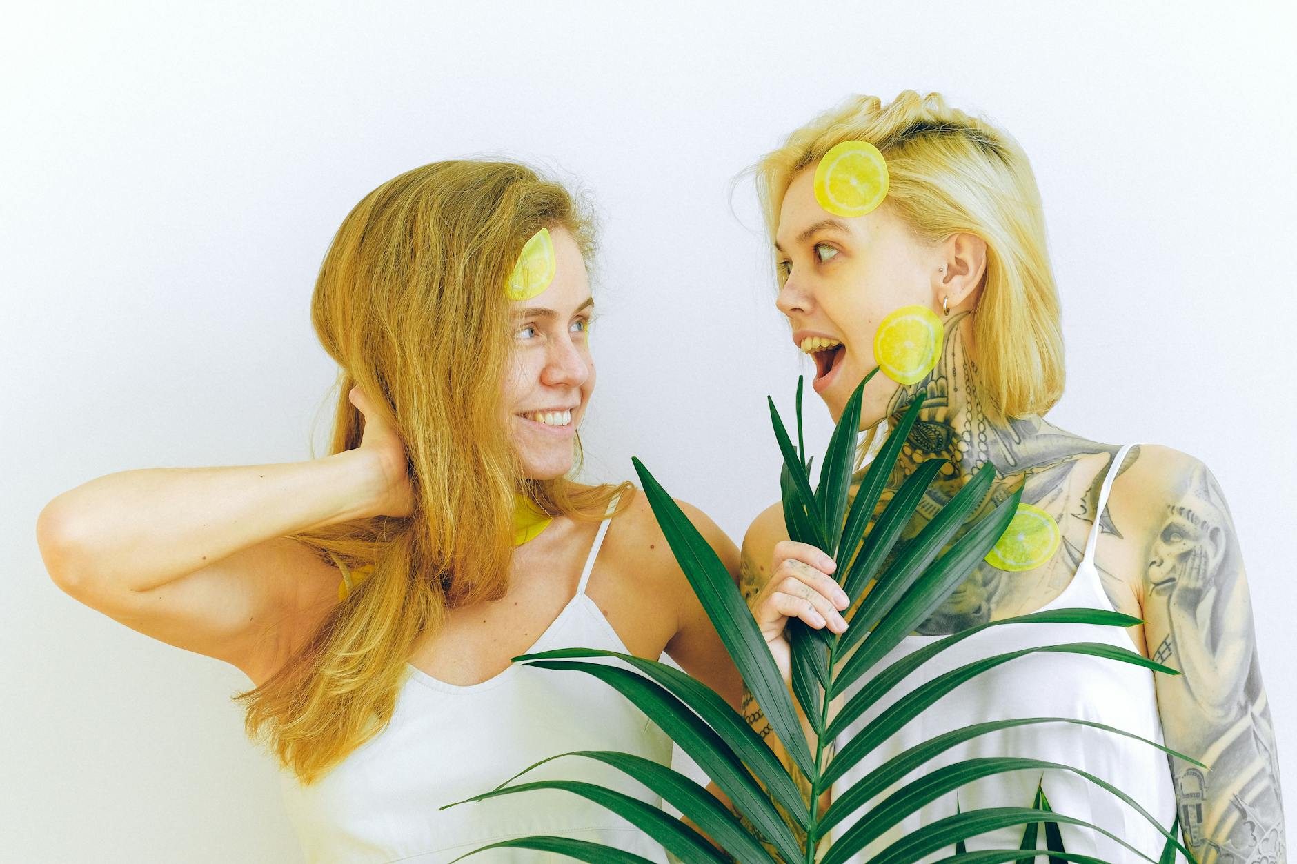 Two women smiling together indoors with natural light, expressing joy and ease